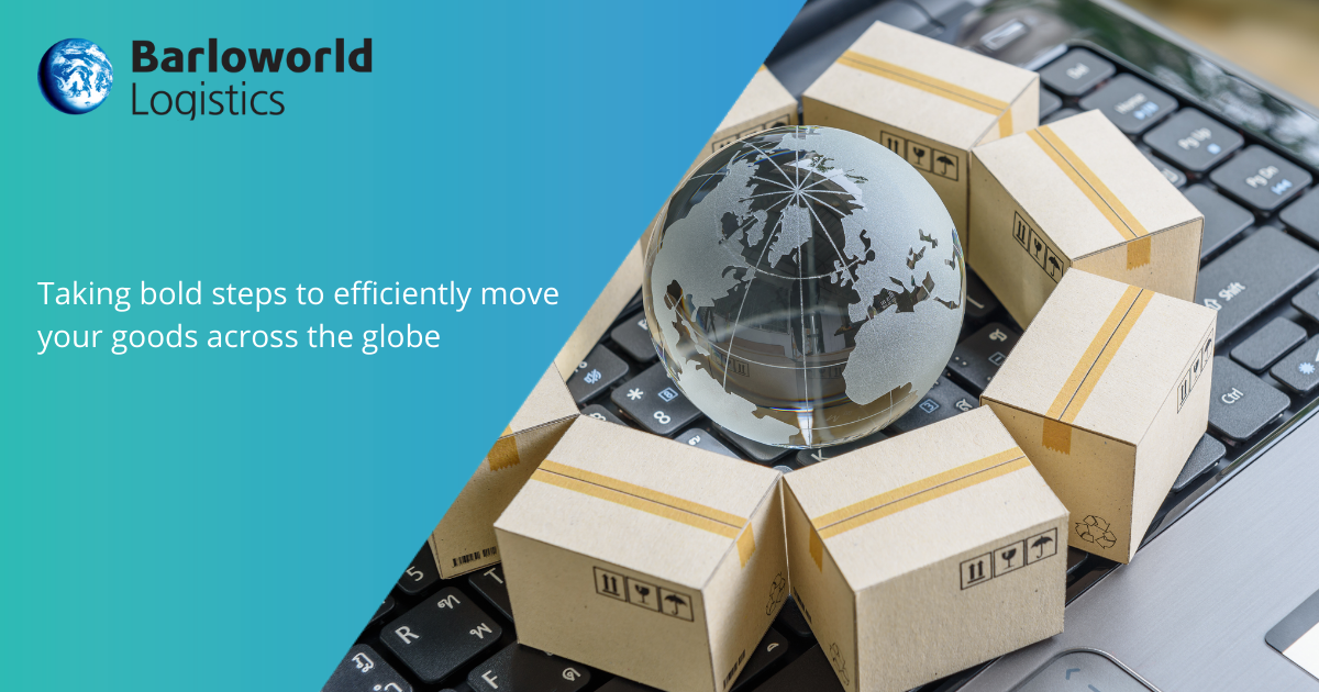 A small, transparent, globe of the Earth surrounded by small delivery boxes on a keyboard